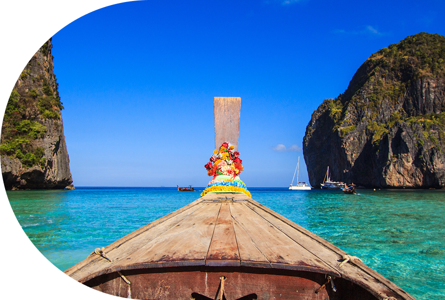 Boat sailing between rocky islands, clear water.