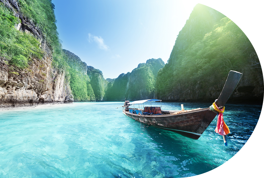 Longtail boat in turquoise bay, limestone cliffs.