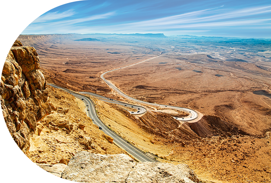 Desert landscape with winding road and sky.